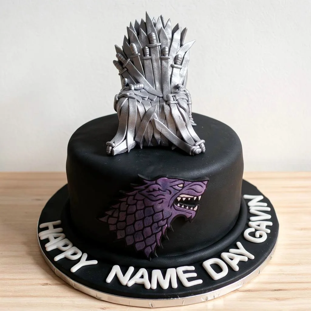 Black round cake with silver iron throne and purple wolf head emblem on side