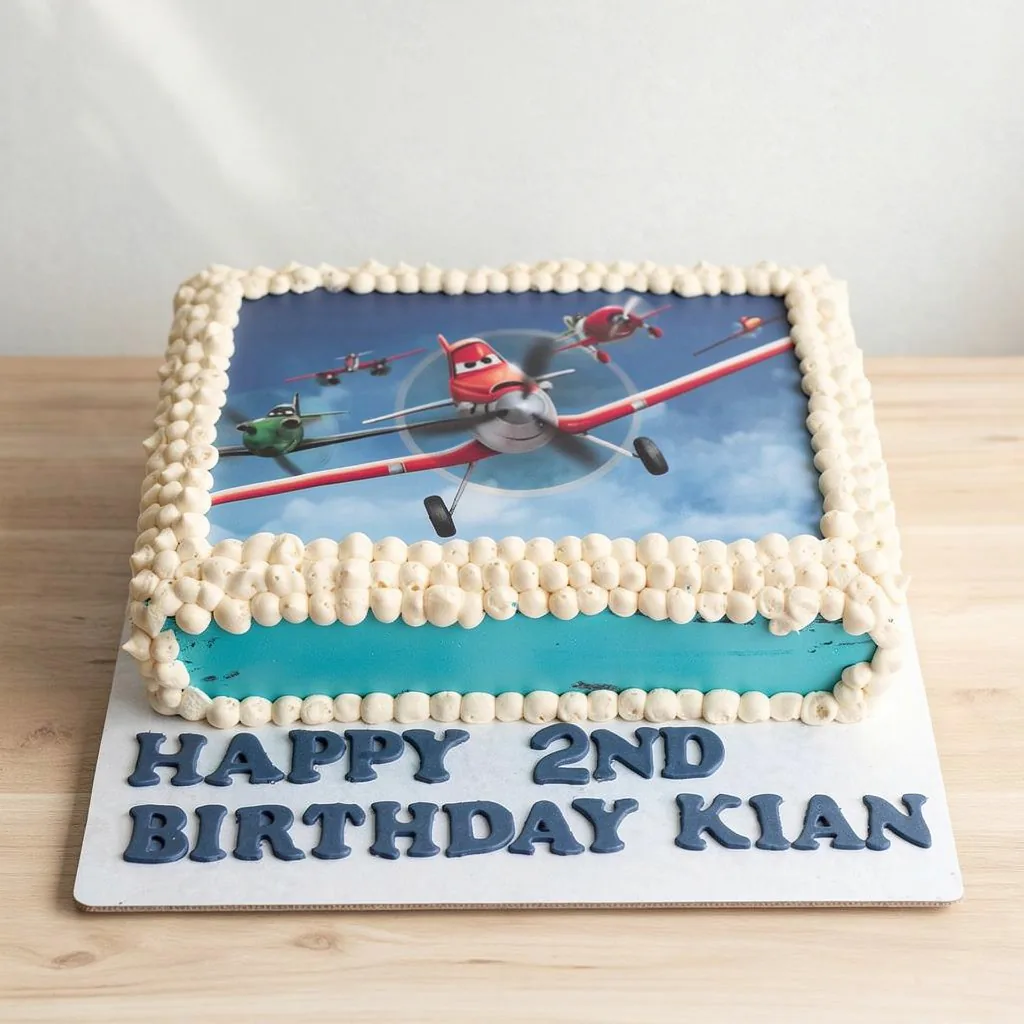 Rectangular blue birthday cake featuring edible airplane characters and white piped border