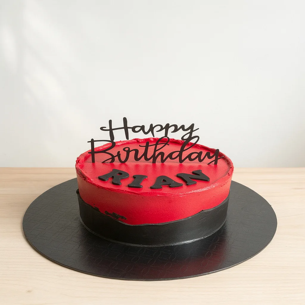 Round cake with red and black frosting and a black happy birthday topper